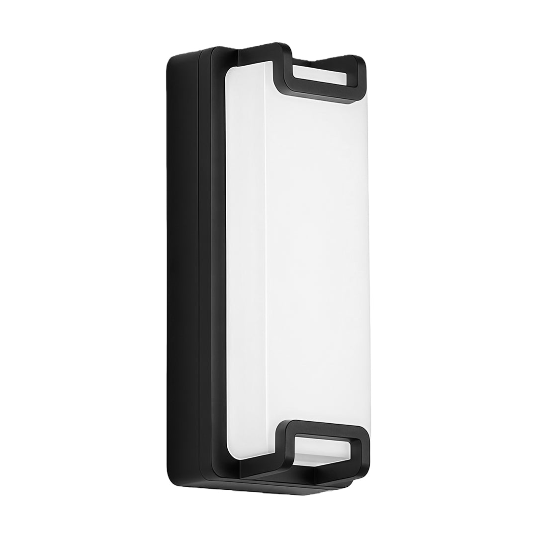 Sleek black outdoor wall sconce with geometric design mounted on a white exterior, casting light on a walk-up path.