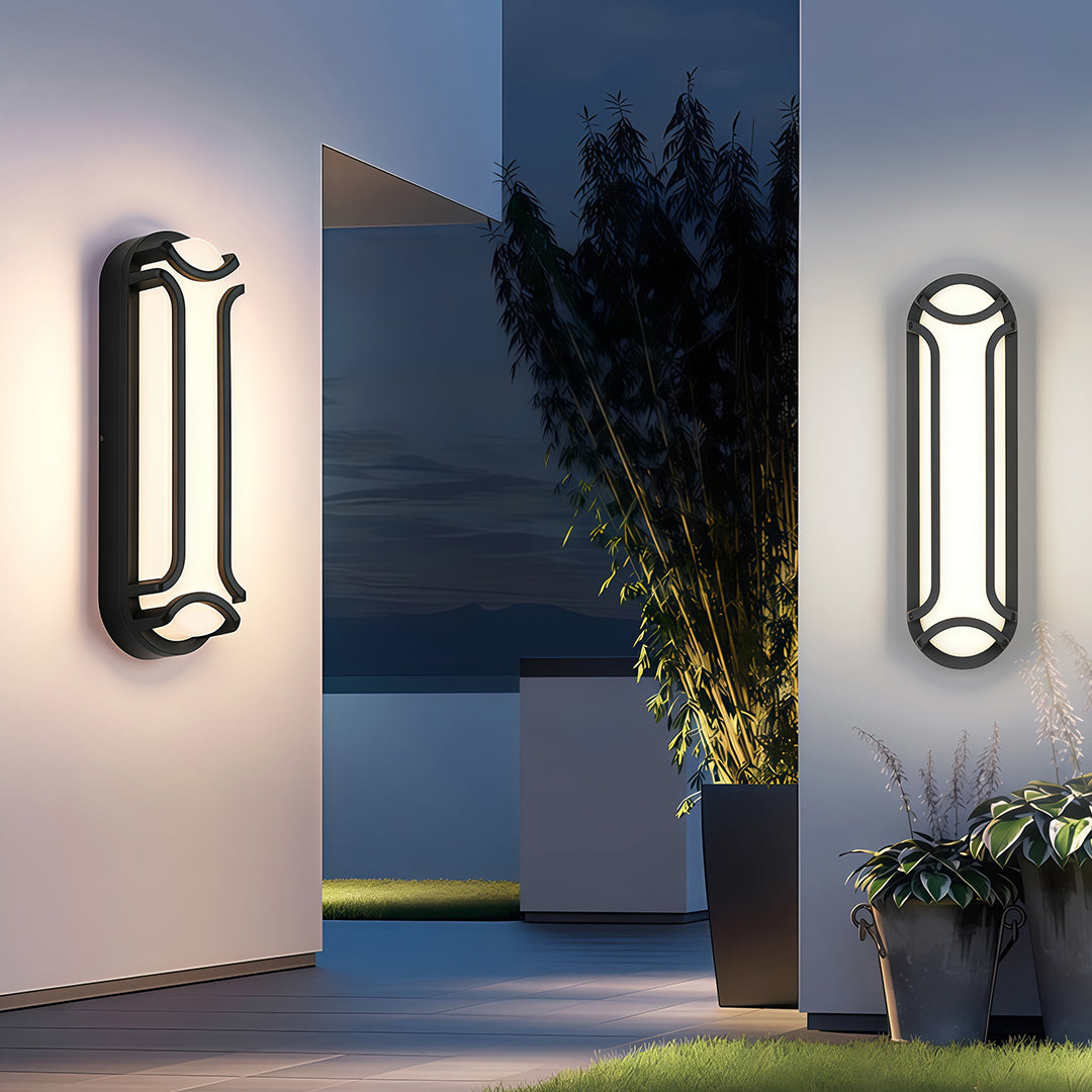 Black outdoor wall sconce mounted on a textured stone wall, adding a touch of modern design to the outdoor ambiance.