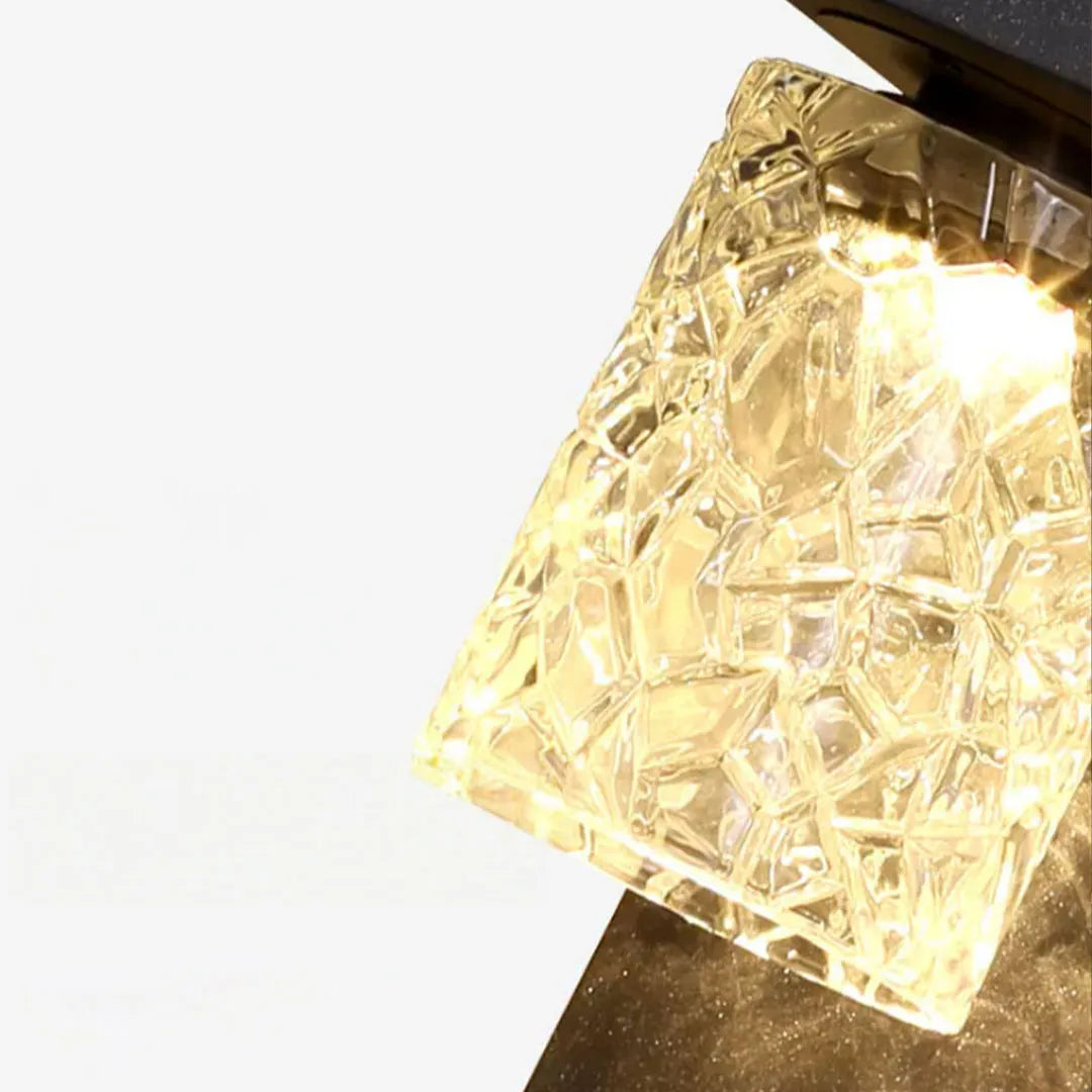 Close-up detail of the textured glass shade on a black sconce wall light.
