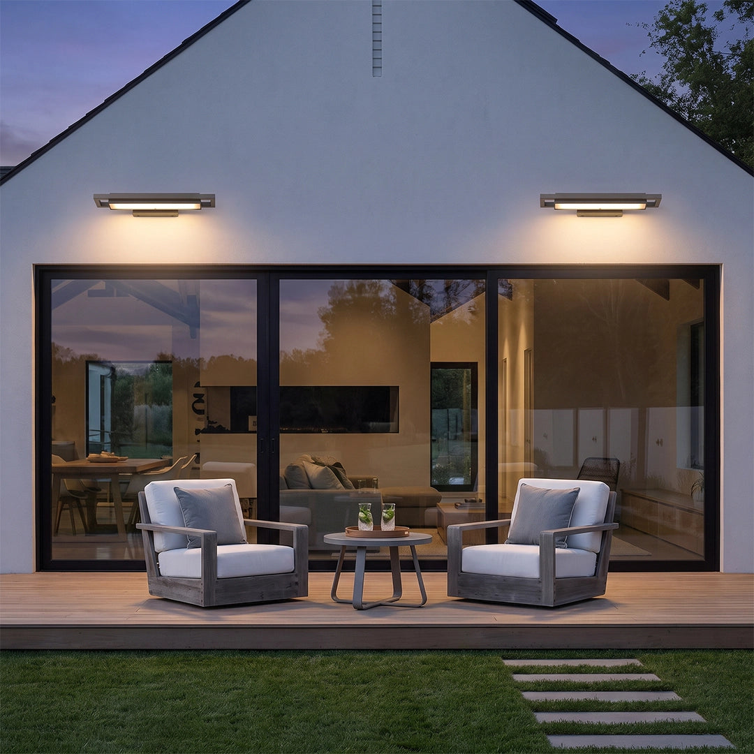 Black sconce wall lights installed above patio doors on a modern home exterior.