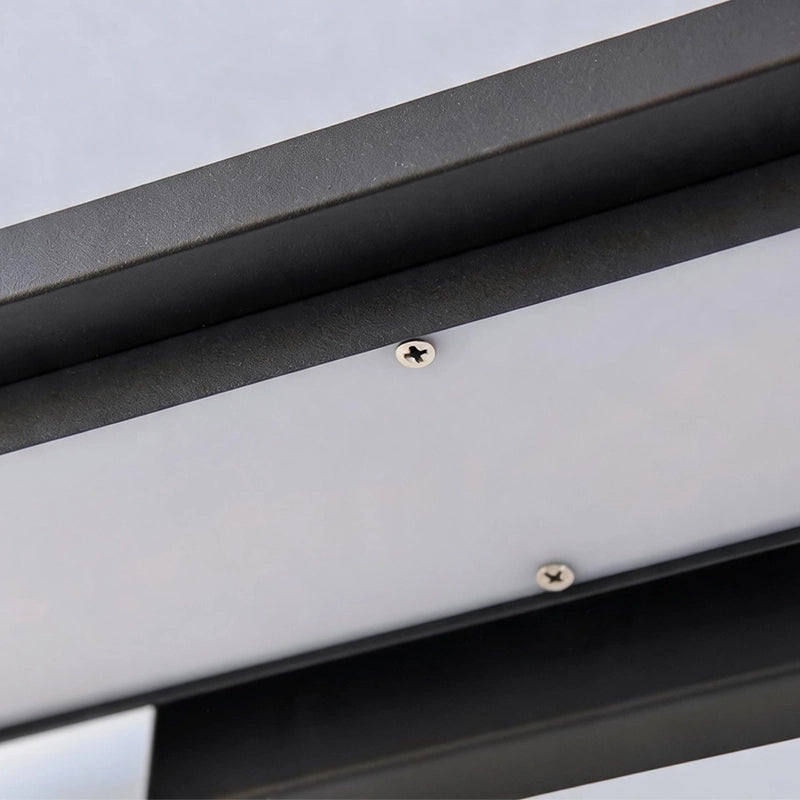 Black sconce wall lights close-up showing the clean metal frame and secure mounting hardware.