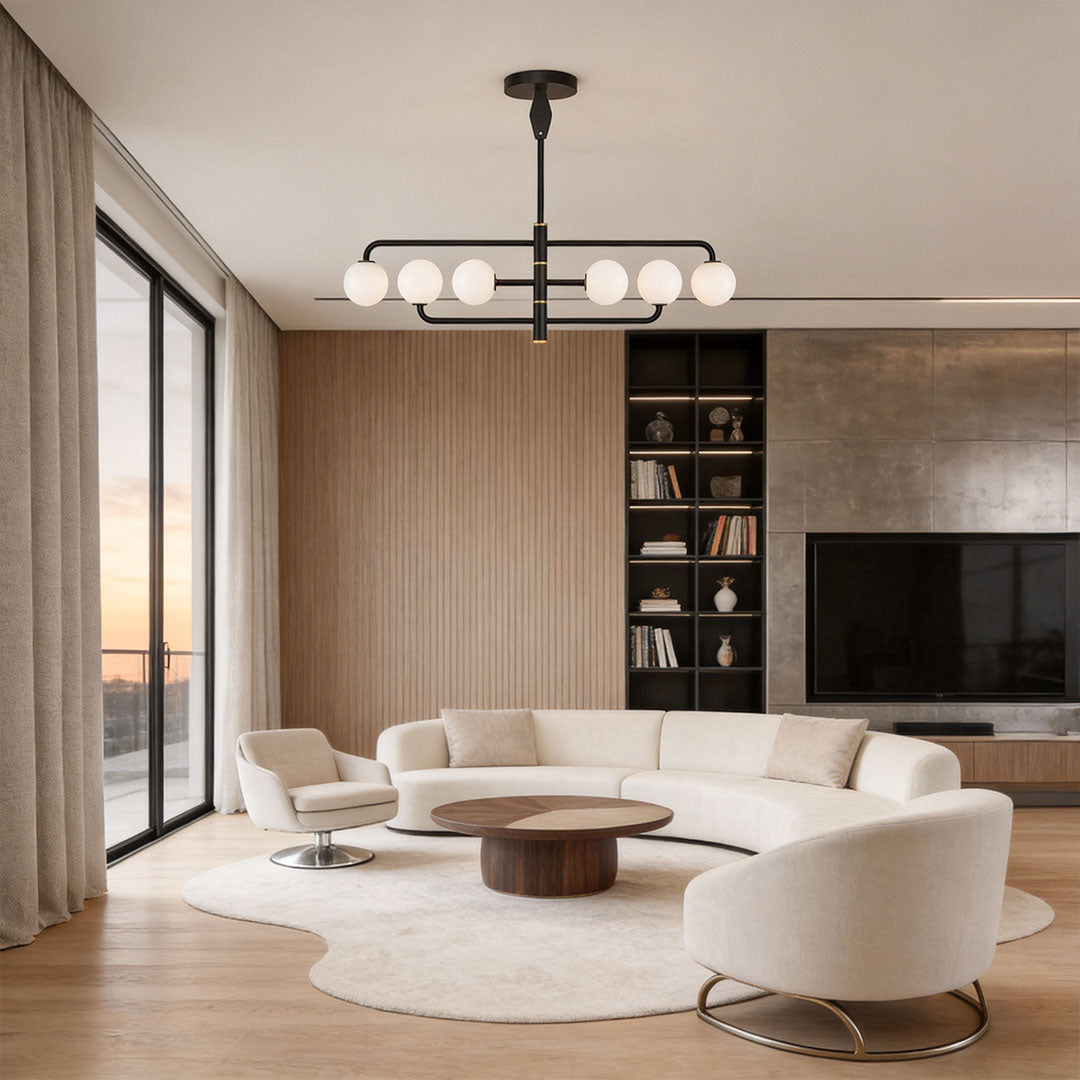 Black semi flush mount light installed in a modern living room with curved seating and floor-to-ceiling drapes.