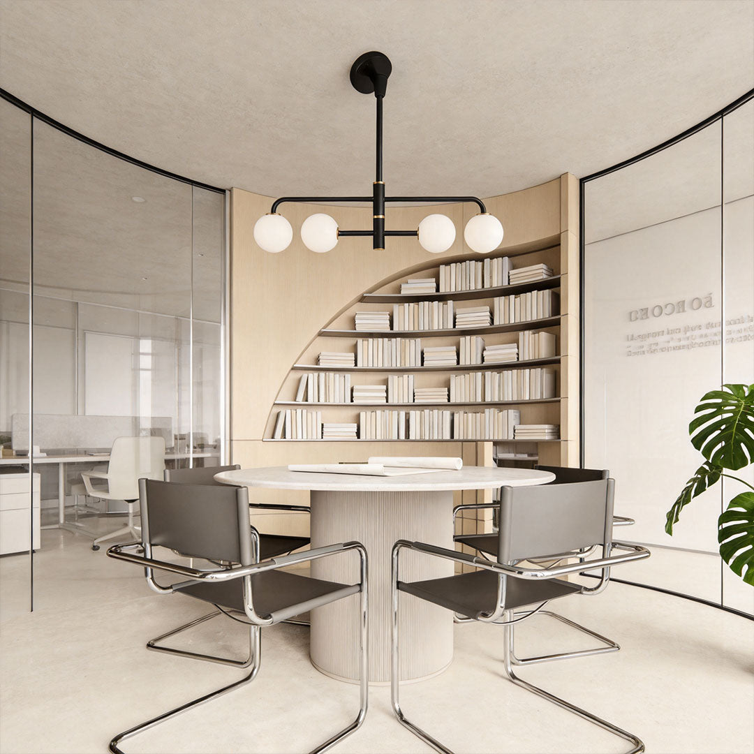Black semi flush mount light suspended above a round meeting table in a contemporary office-style interior.