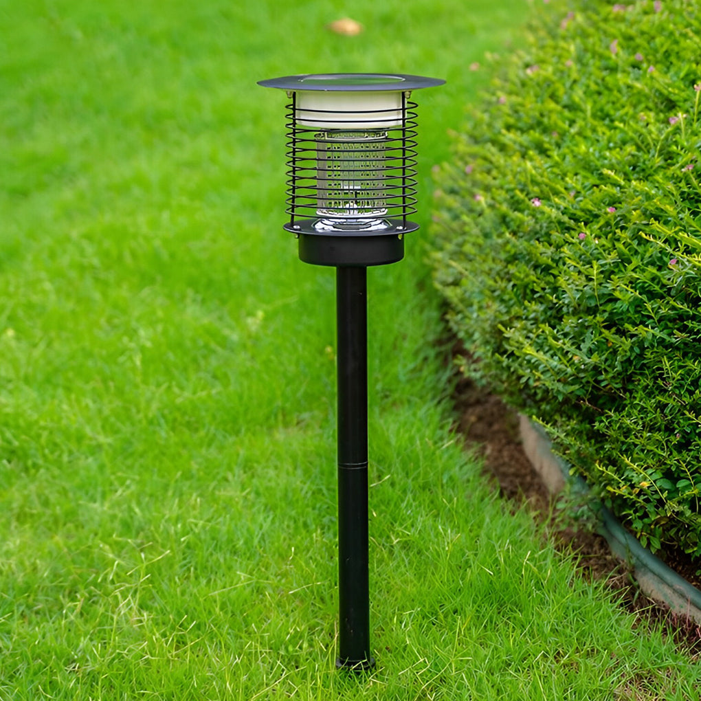 Black solar bug zapper post light standing on lawn.