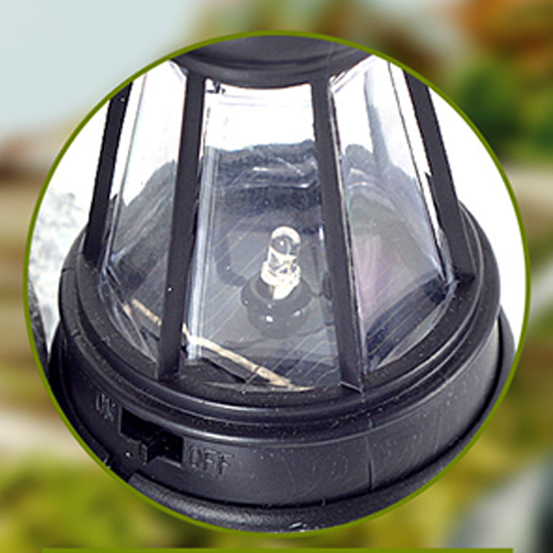 Close-up view of black solar panel cap with LED light mechanism for garden lantern system