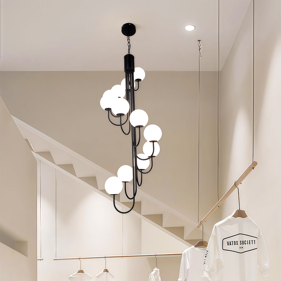 Black spiral globe chandelier featuring multiple frosted glass globes suspended from ceiling.
