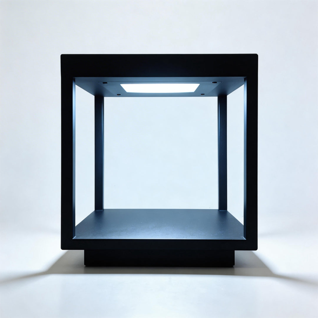 Black square concrete pillar lights with cool white LED illumination for modern garden fences.