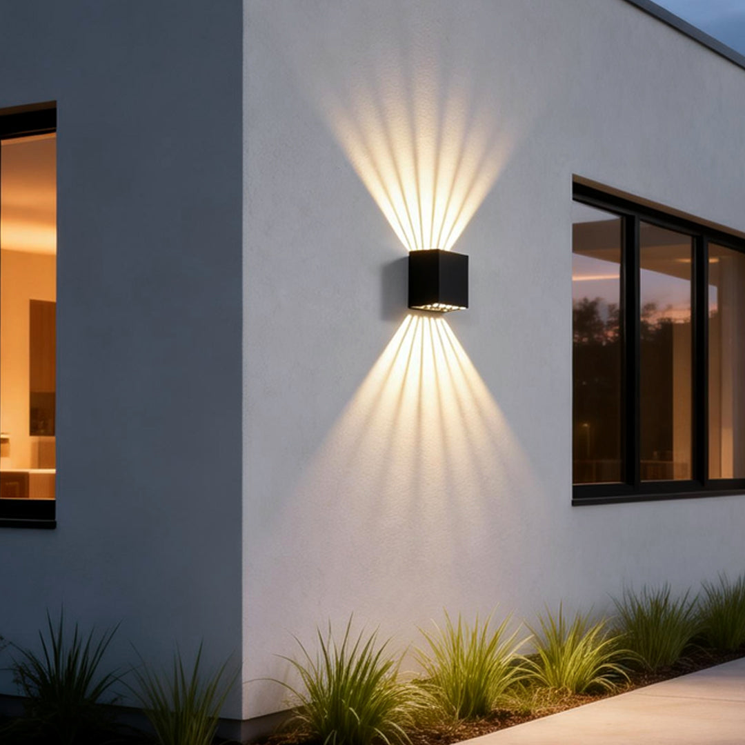 Black square outdoor wall lights enhancing a contemporary exterior wall with elegant ambient light.
