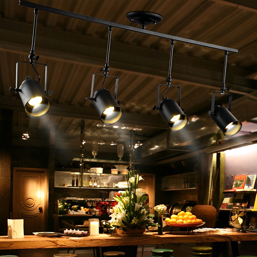 Black track light with adjustable spotlights, highlighting a cozy café interior.