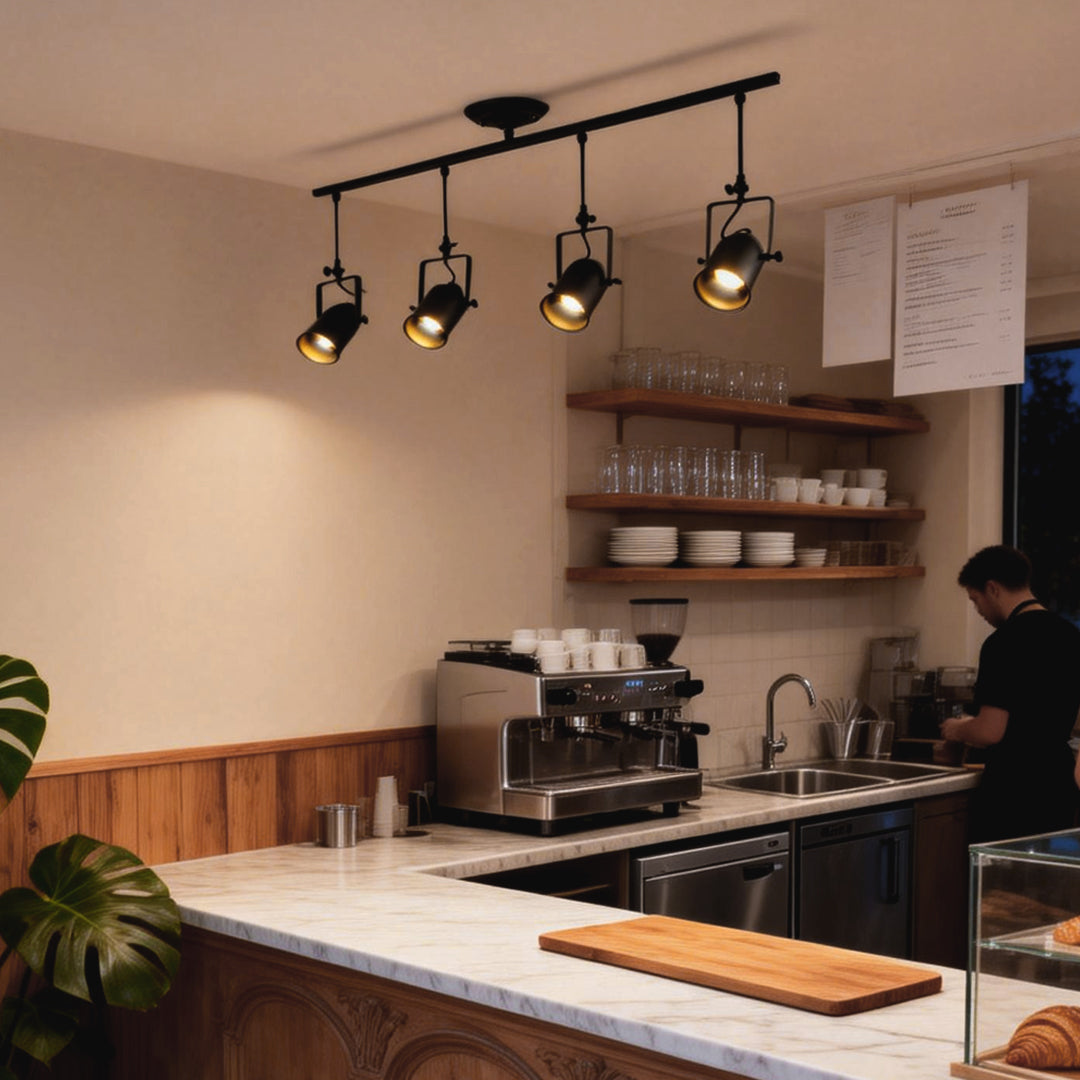 Black track light system illuminating a modern coffee shop counter with wooden shelves.