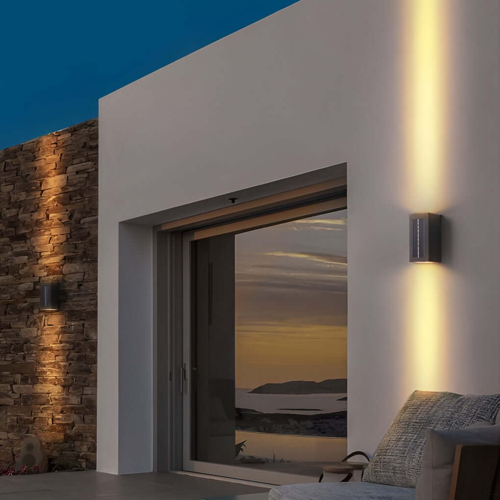 Black up down wall light highlighting outdoor architectural wall