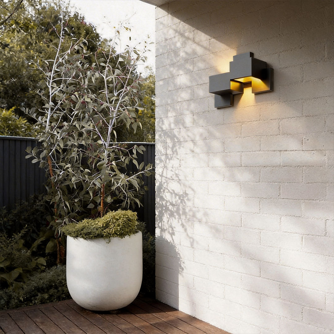 Close-up of black up down wall lights showcasing its geometric design and warm light.
