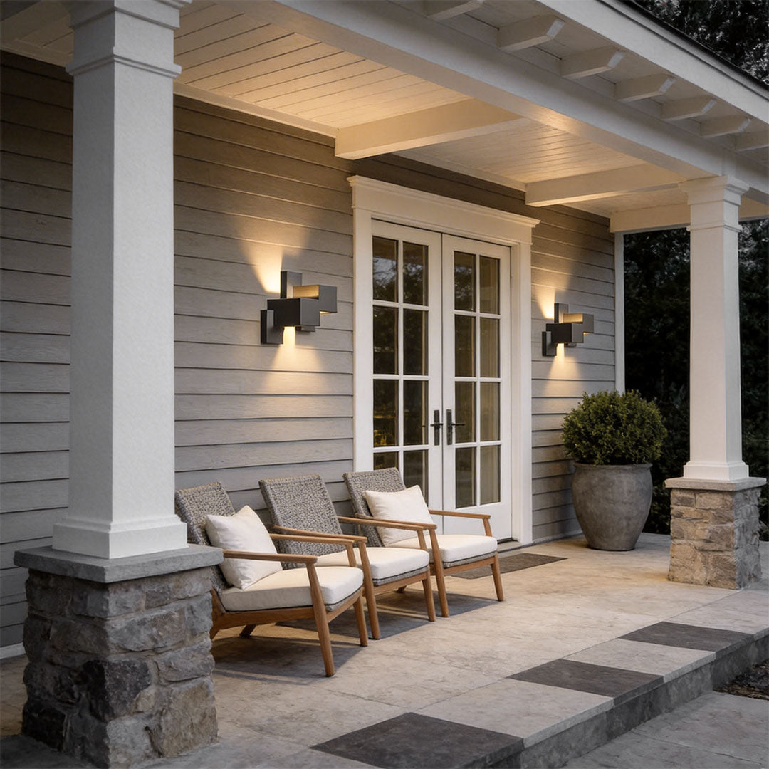 Black up down wall lights with a contemporary design, enhancing a patio seating area.