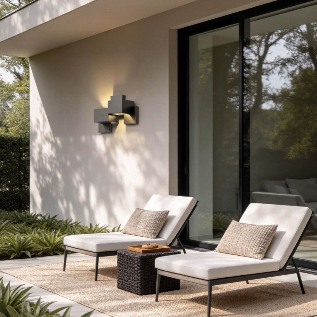 Black up down wall lights with a modern design, providing warm illumination near a porch.