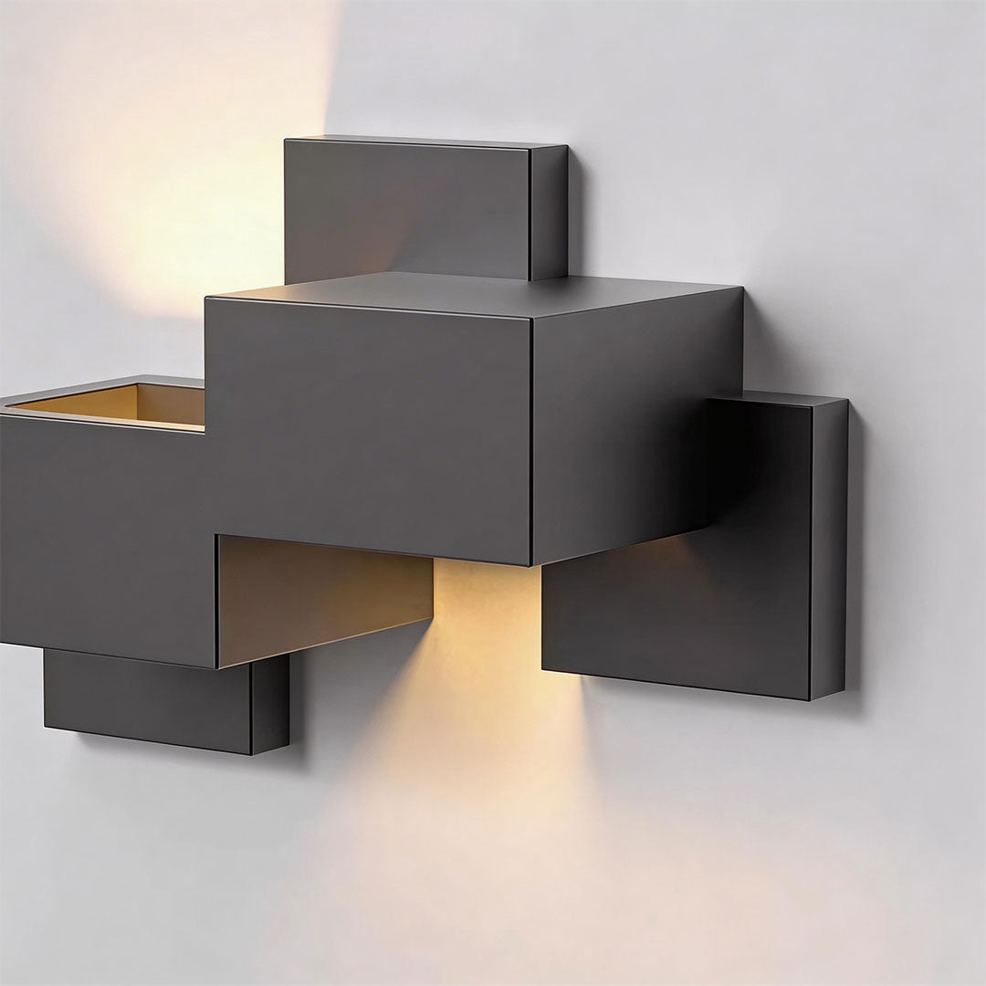 Black up down wall lights with a sleek design, mounted on a white wall.