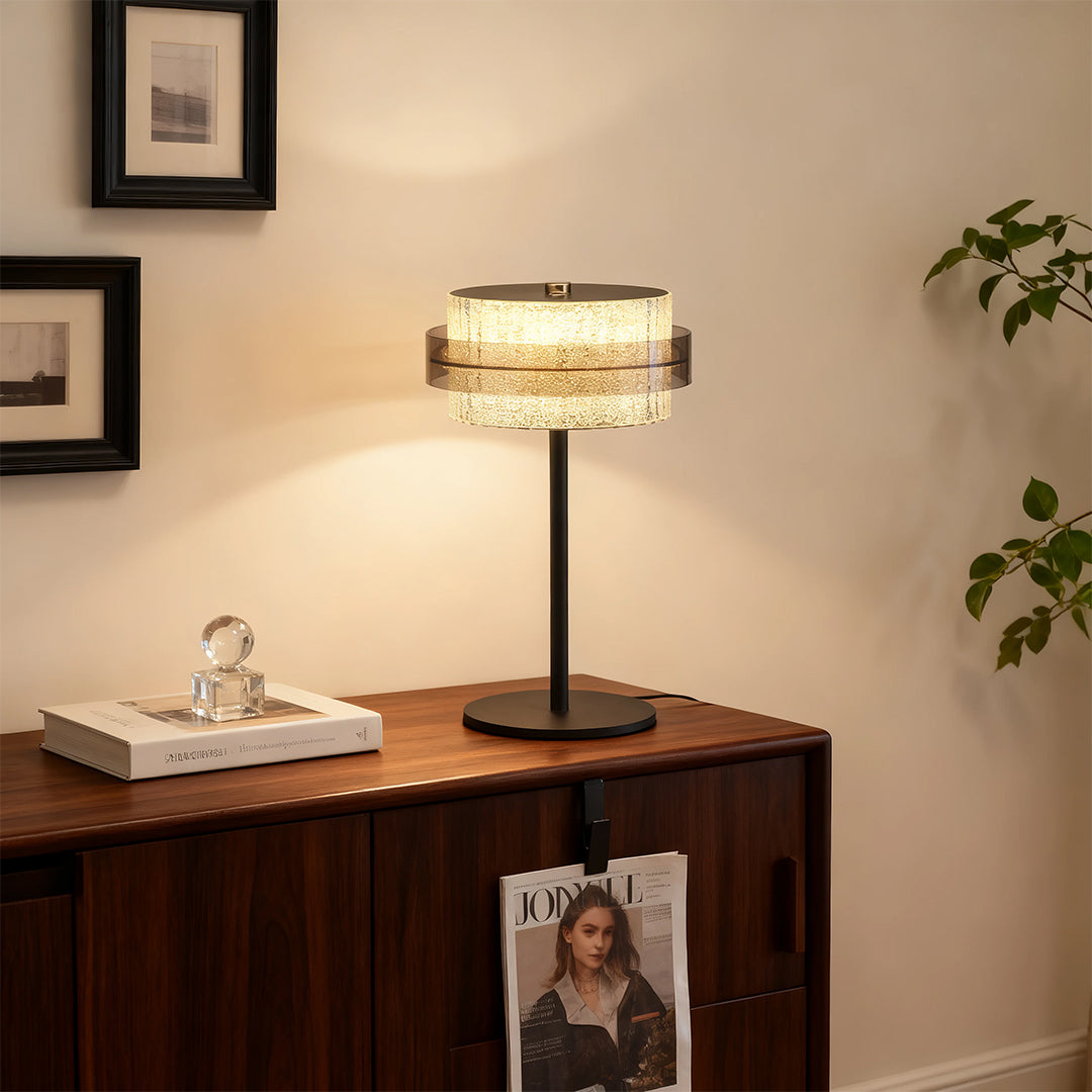 Black vintage metal table lamp style with a crystal fringe shade on a dark wood cabinet nightstand.