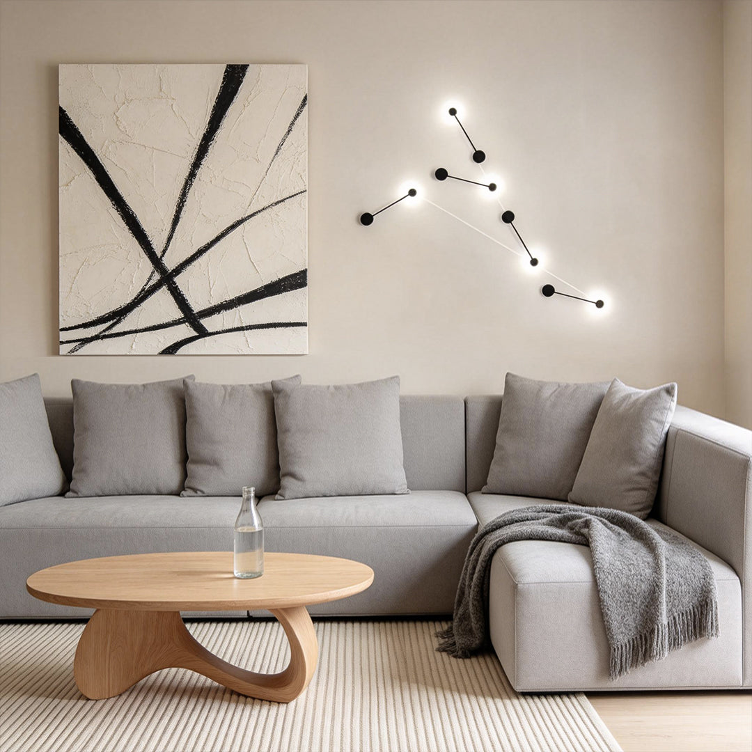 Black wall light enhancing a contemporary sofa area with elegant ambient light.
