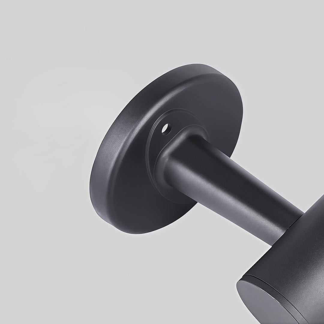 Black outdoor wall mount light installed near the entrance of a house, offering bright and effective lighting.