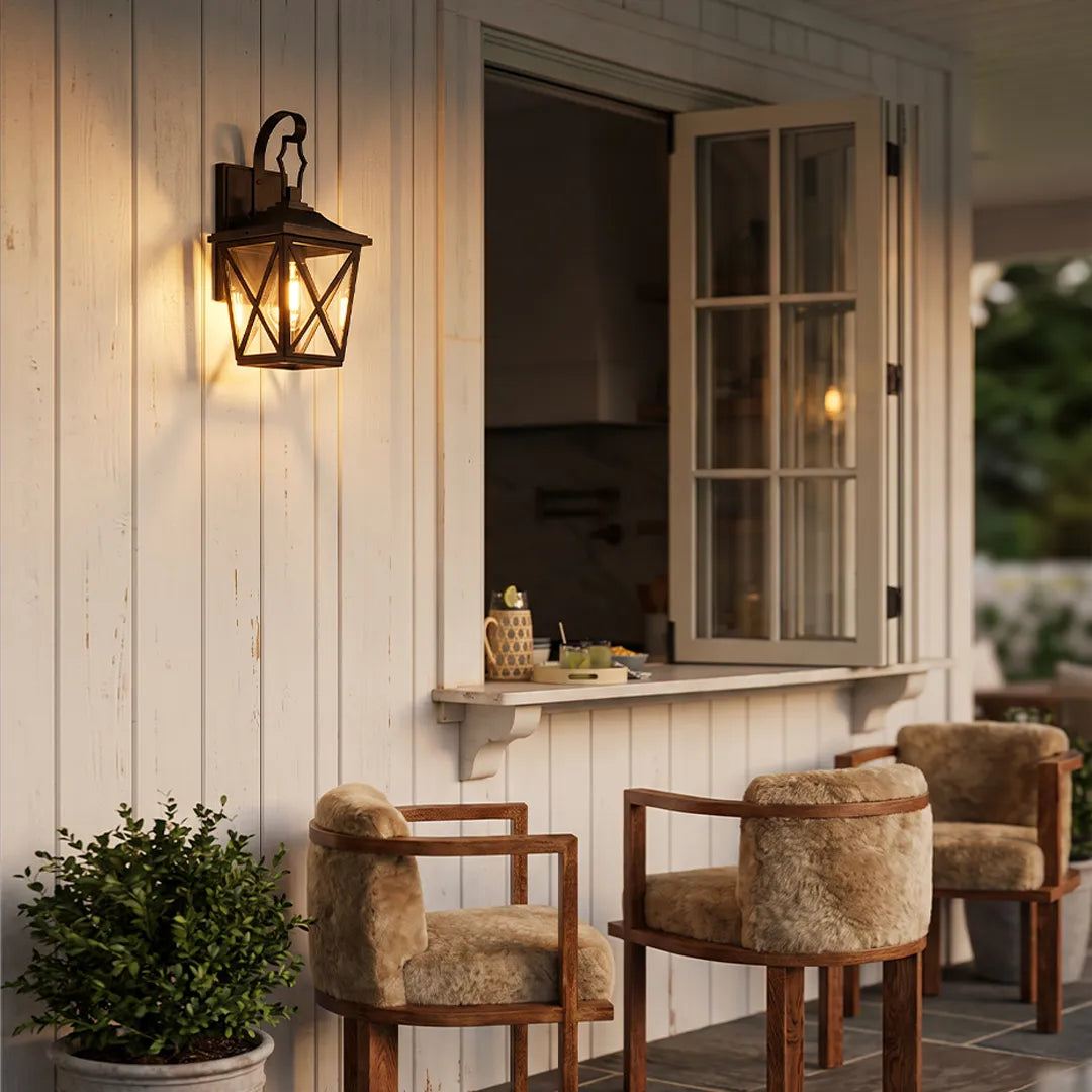 Black wall lighting installed beside an open window on white siding, adding warm decorative outdoor illumination.