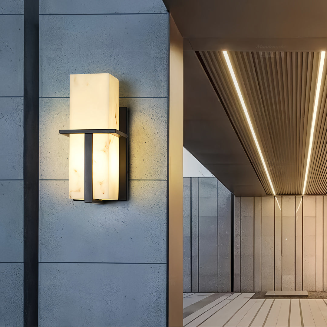 Black wall lights mounted on blue-gray exterior wall creating dramatic upward and downward light effect