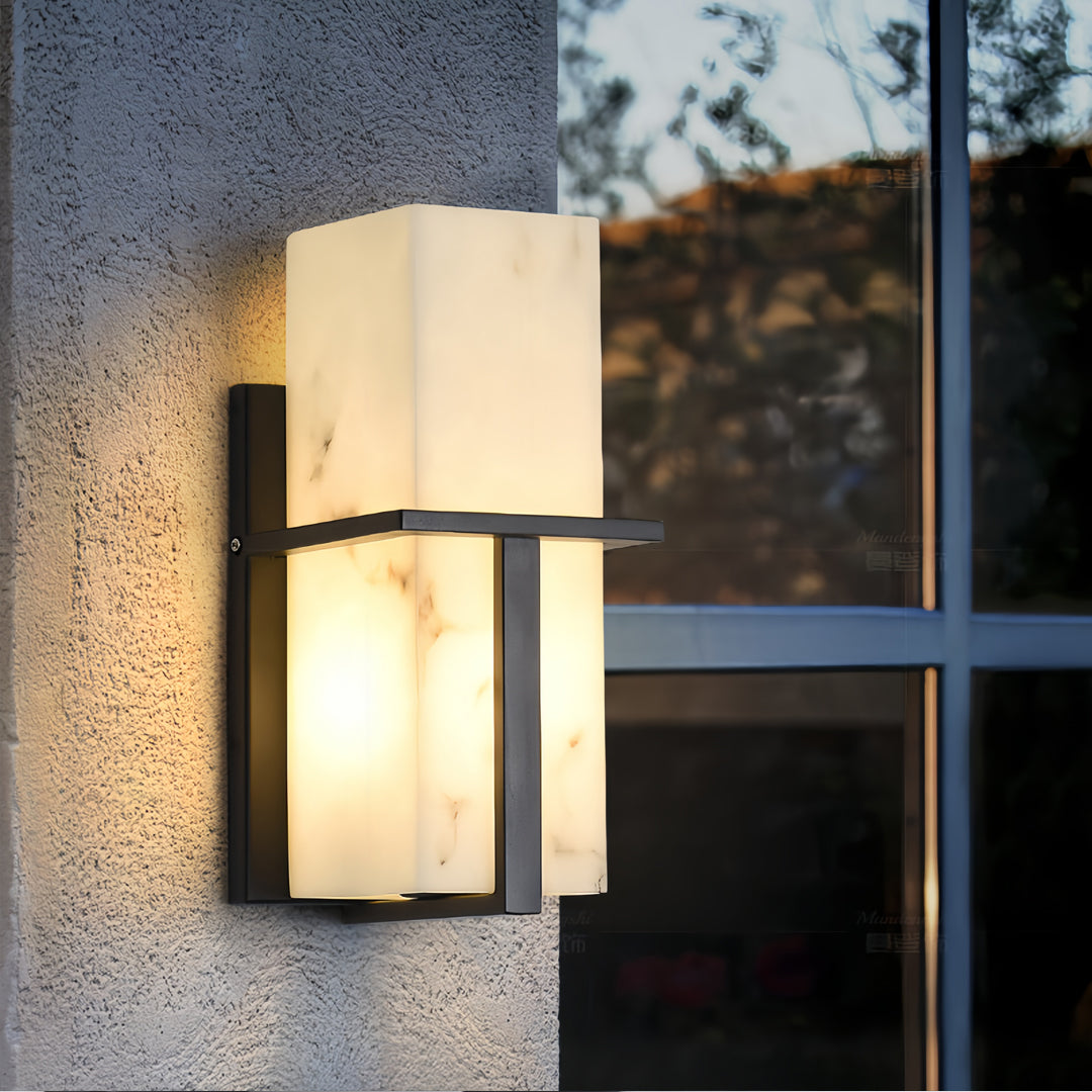 Black wall lights illuminating exterior textured wall beside window creating warm ambient outdoor lighting