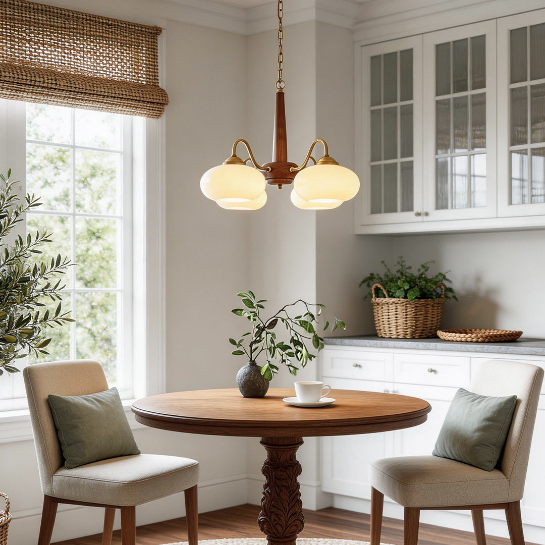 Black walnut brass chandelier illuminating a classic dining room with warm ambient glow.