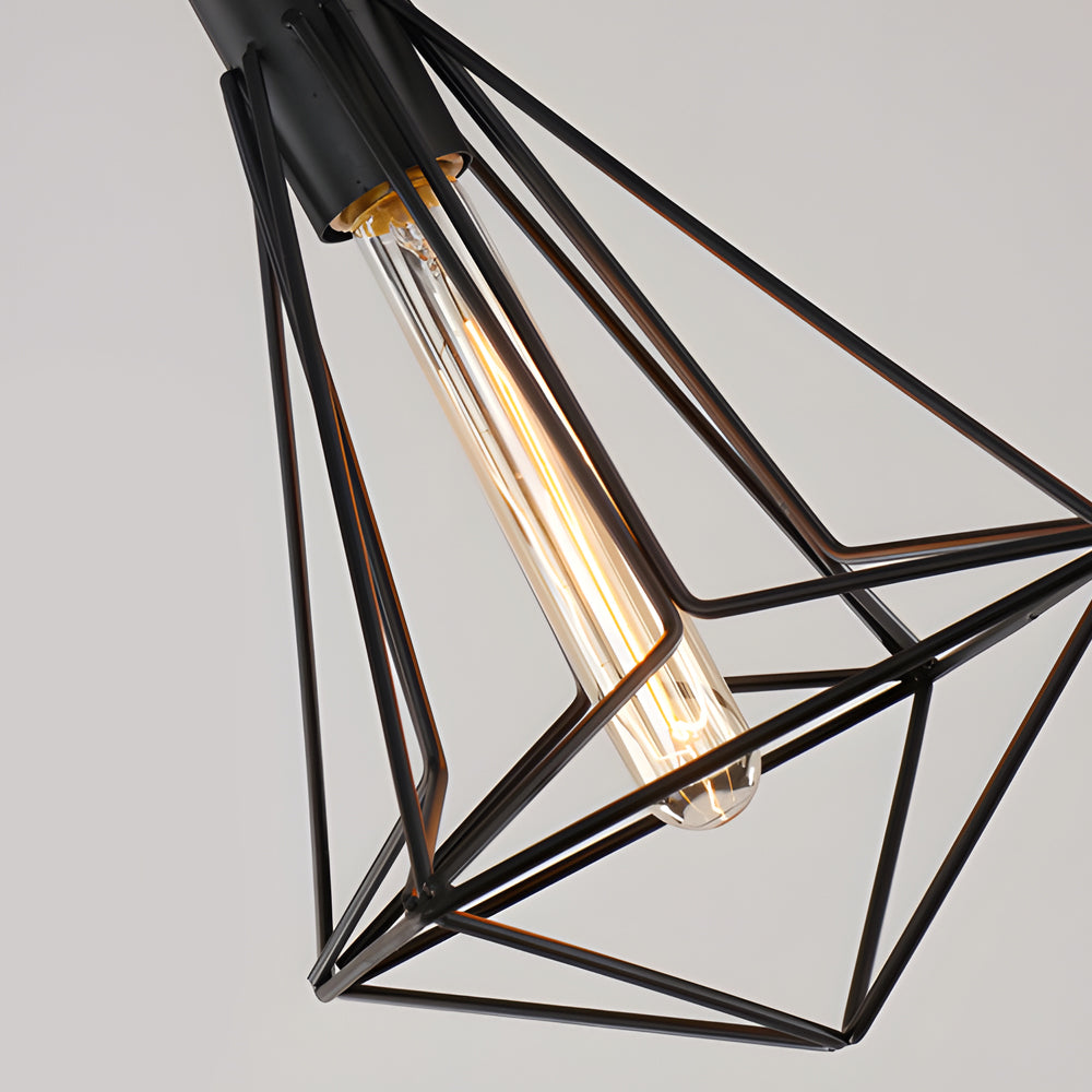 Black wire cage pendant light with a close-up of the Edison bulb inside.