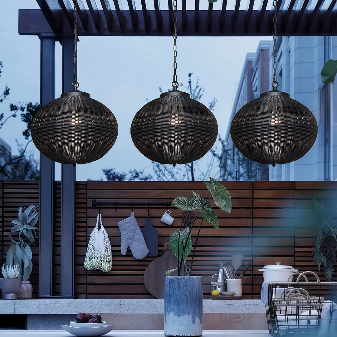 Black woven pendant light casting a soft glow in an outdoor seating area, ideal for relaxed evenings.