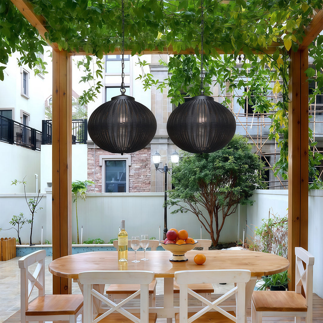 Black woven pendant lights illuminating a balcony with a scenic view, creating an elegant outdoor ambiance.
