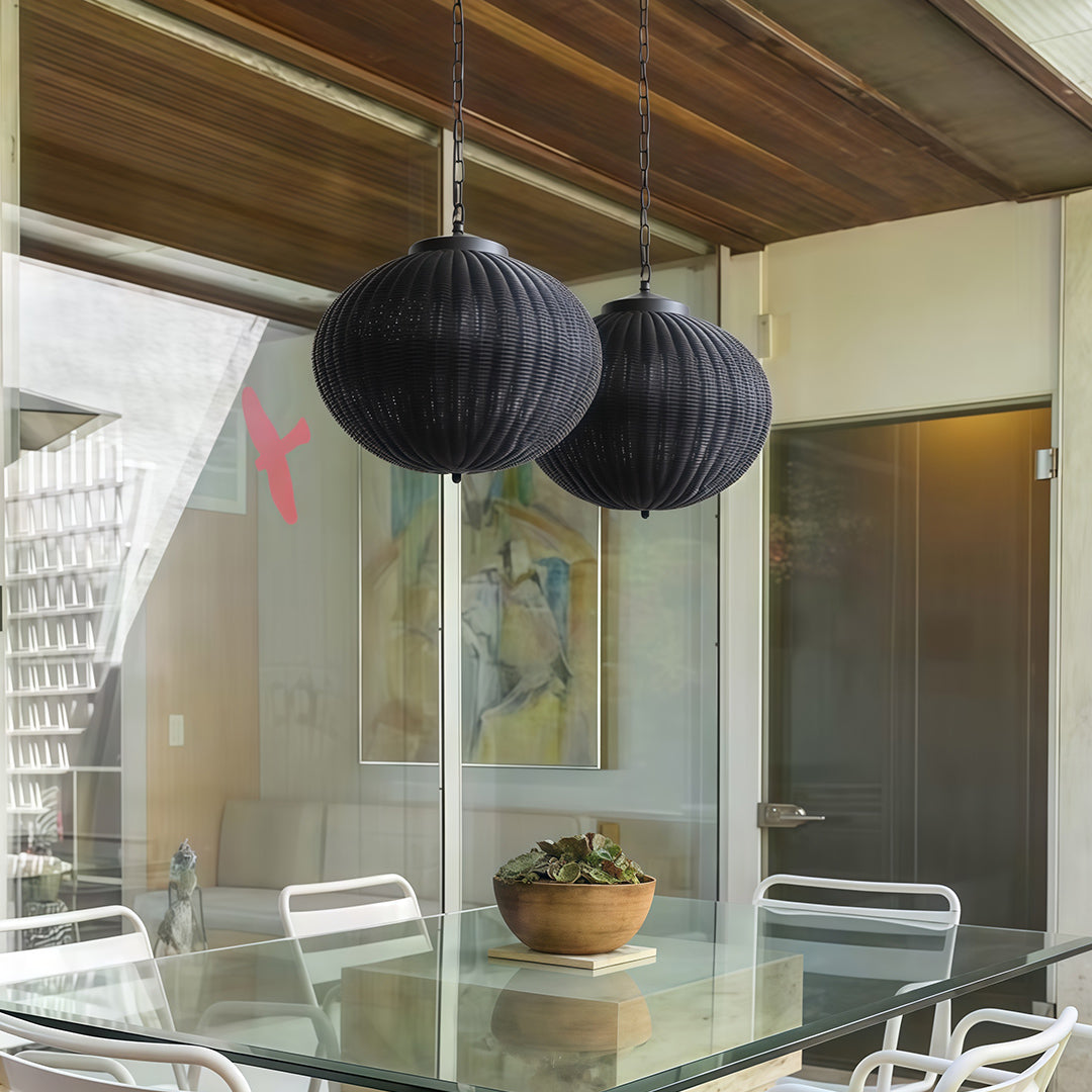 Set of black woven pendant lights hanging over a poolside, enhancing the modern outdoor space.