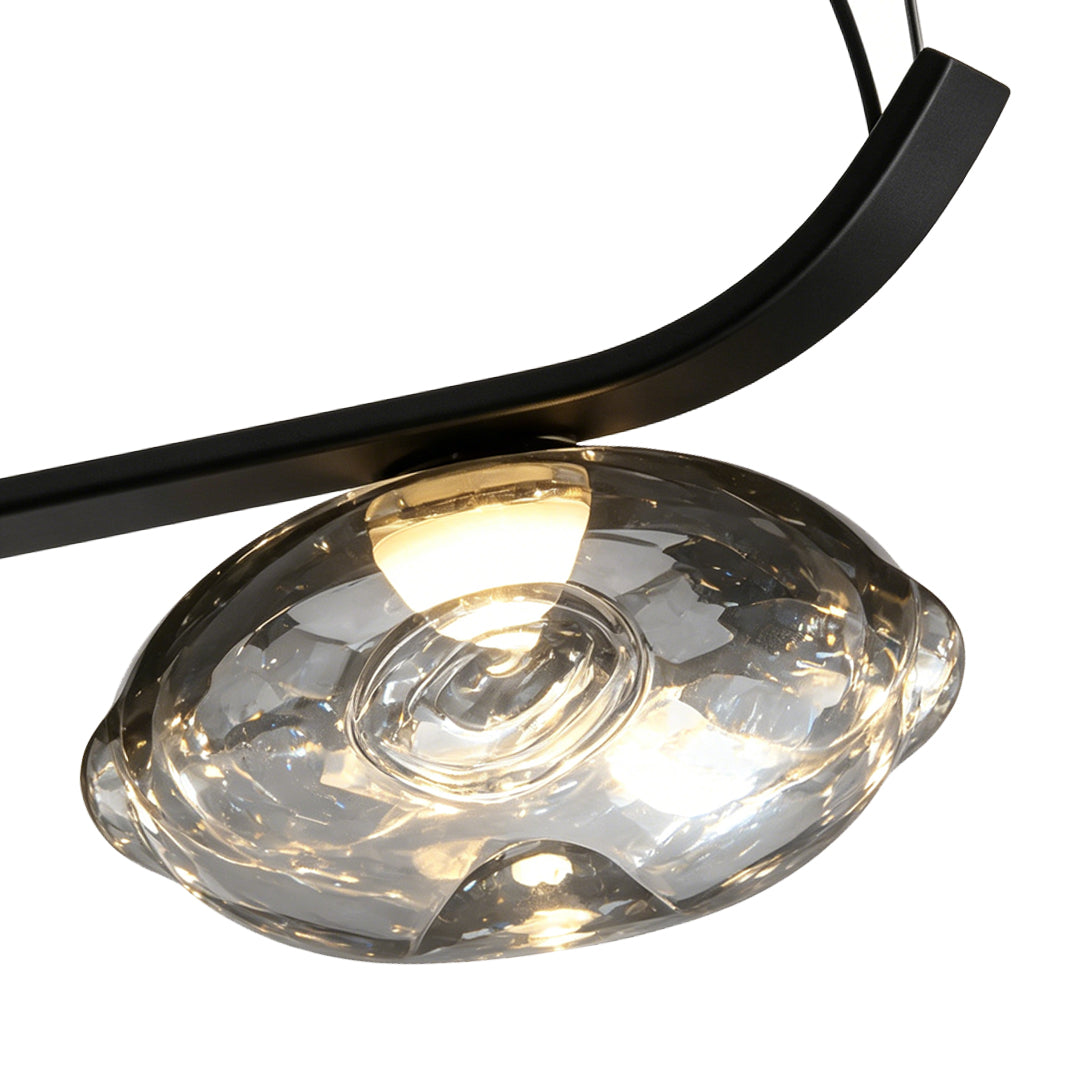 Detailed view of black wrought iron arm and glass light fixture design.