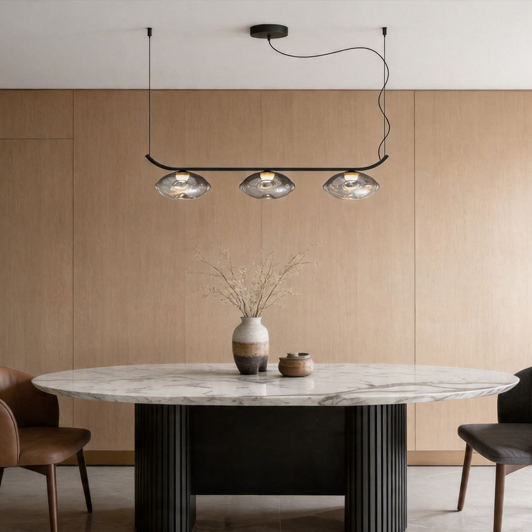 Black wrought iron chandelier in a contemporary dining room with wood wall background.