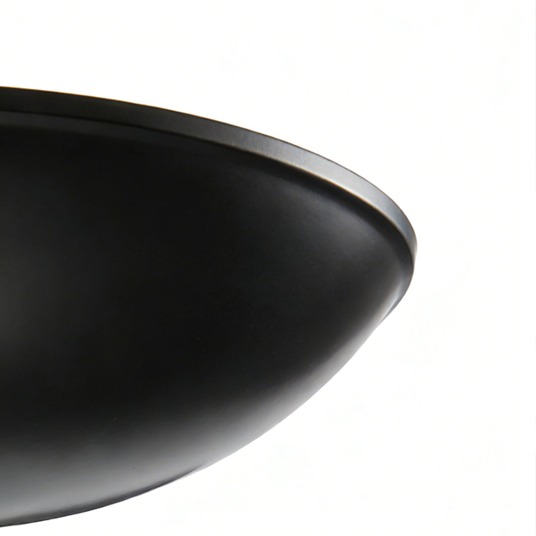 Close up of a matte black shade from black and gold chandeliers, showing smooth curved metal design with modern luxury style.
