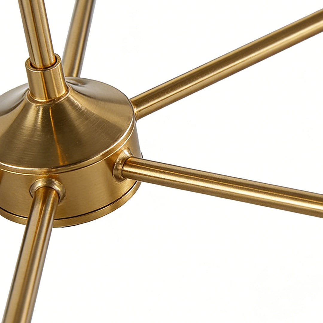 Detailed view of gold metal arms and center hub from black and gold chandeliers, highlighting brushed brass finish and modern structure.
