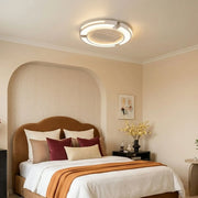 Bladeless ceiling fan with lighting installed in a modern bedroom with warm ambient illumination.