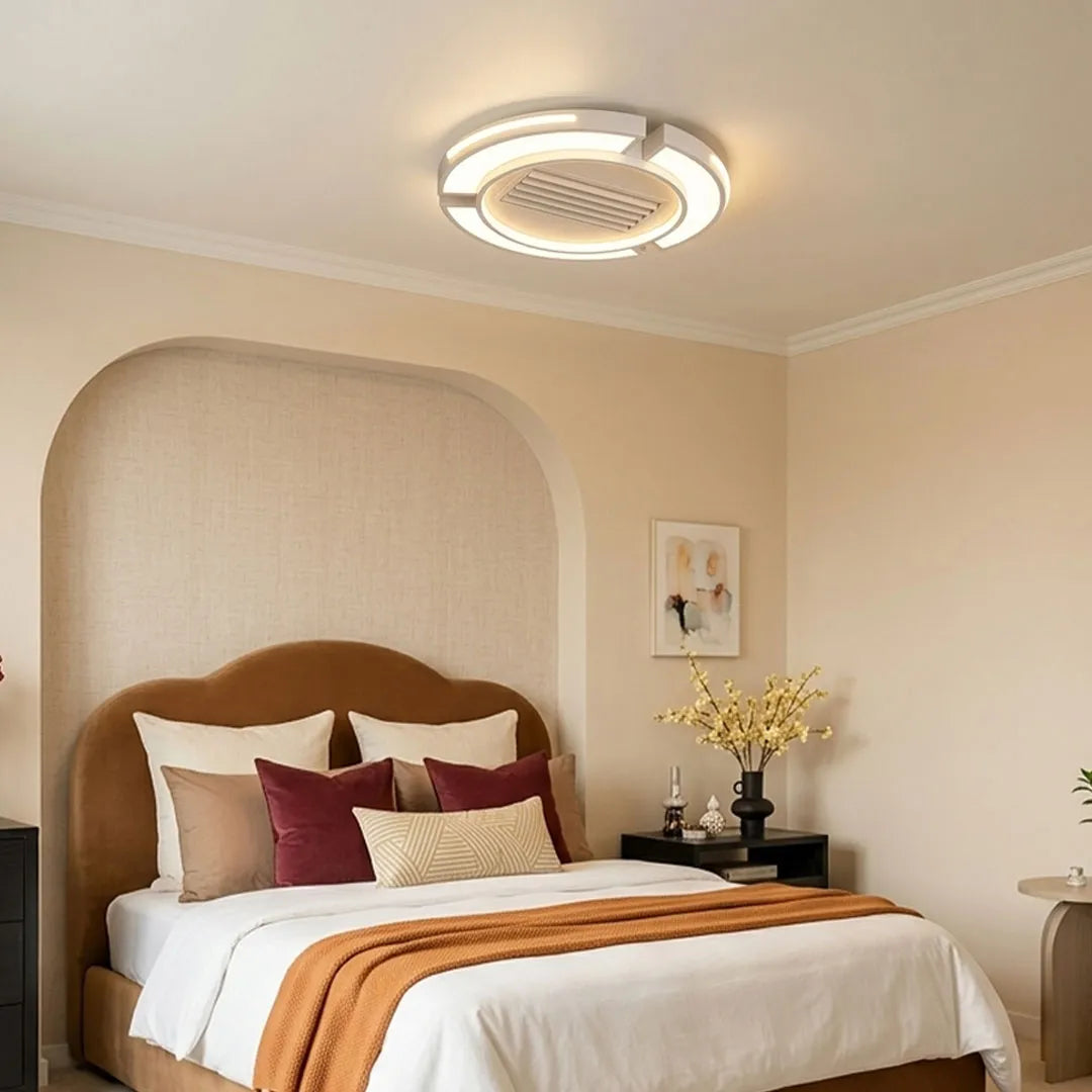 Bladeless ceiling fan with lighting installed in a modern bedroom with warm ambient illumination.