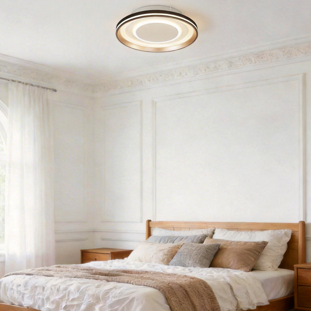 Bladeless ceiling fan with lighting above a cozy bed, enhancing room ambiance.
