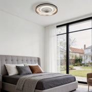 Bladeless ceiling fan with lighting in a modern bedroom, providing soft illumination and airflow.