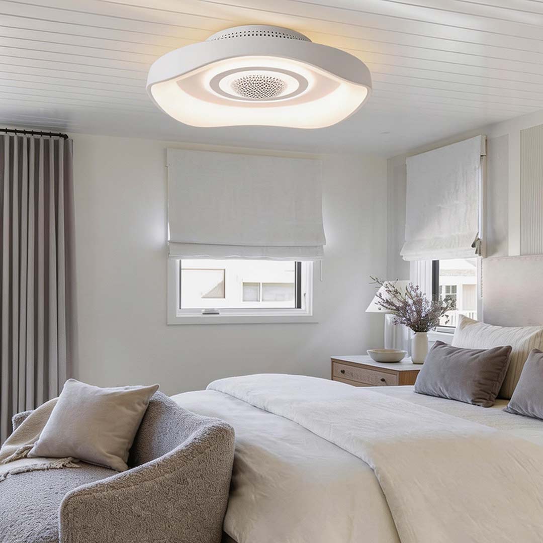 Bladeless fan with light above a cozy bed, enhancing room ambiance with soft light.