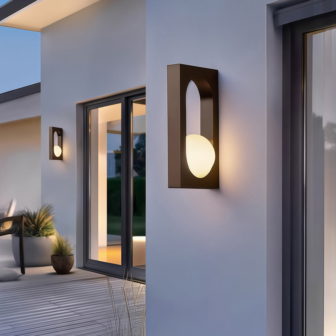 Sleek outdoor wall light installed on a blue-toned exterior wall, demonstrating elegant led outdoor wall lighting ideas for modern houses.