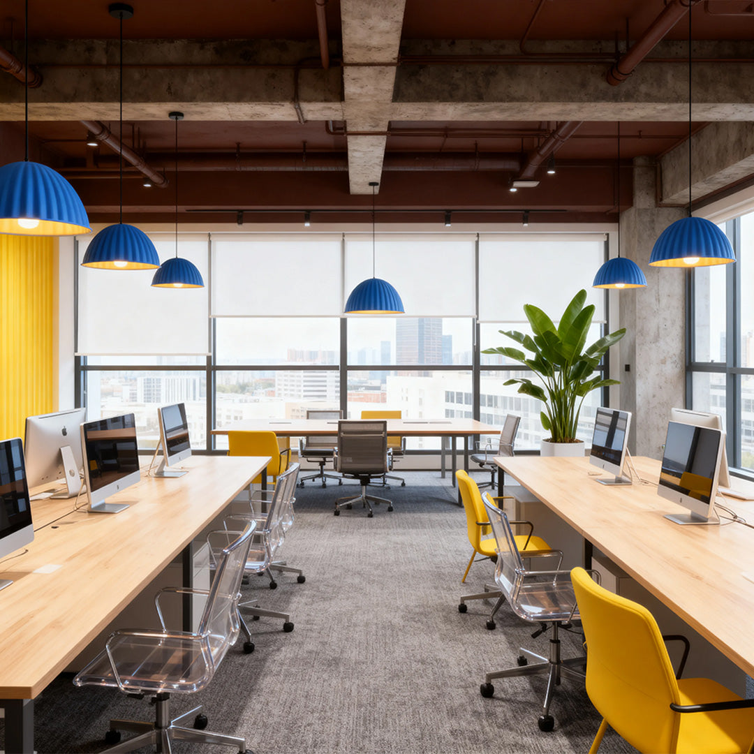 Blue fluted pendant light fixtures installed over wooden workstations in a modern, open-plan office (Optimized for gray pendant light search context).