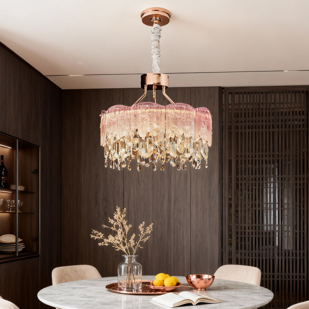 Dining space illuminated by blue glass fringe chandelier with soft ambient lighting.