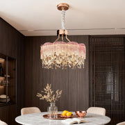 Dining space illuminated by blue glass fringe chandeliers with soft ambient lighting.