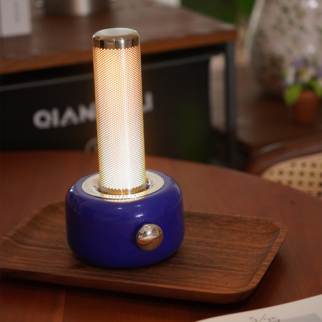 Blue industrial metal USB rechargeable table lamp on wooden table in cozy interior setting