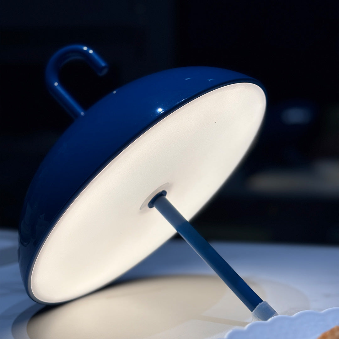 Blue USB rechargeable table lamp illuminated showing warm light output and modern design