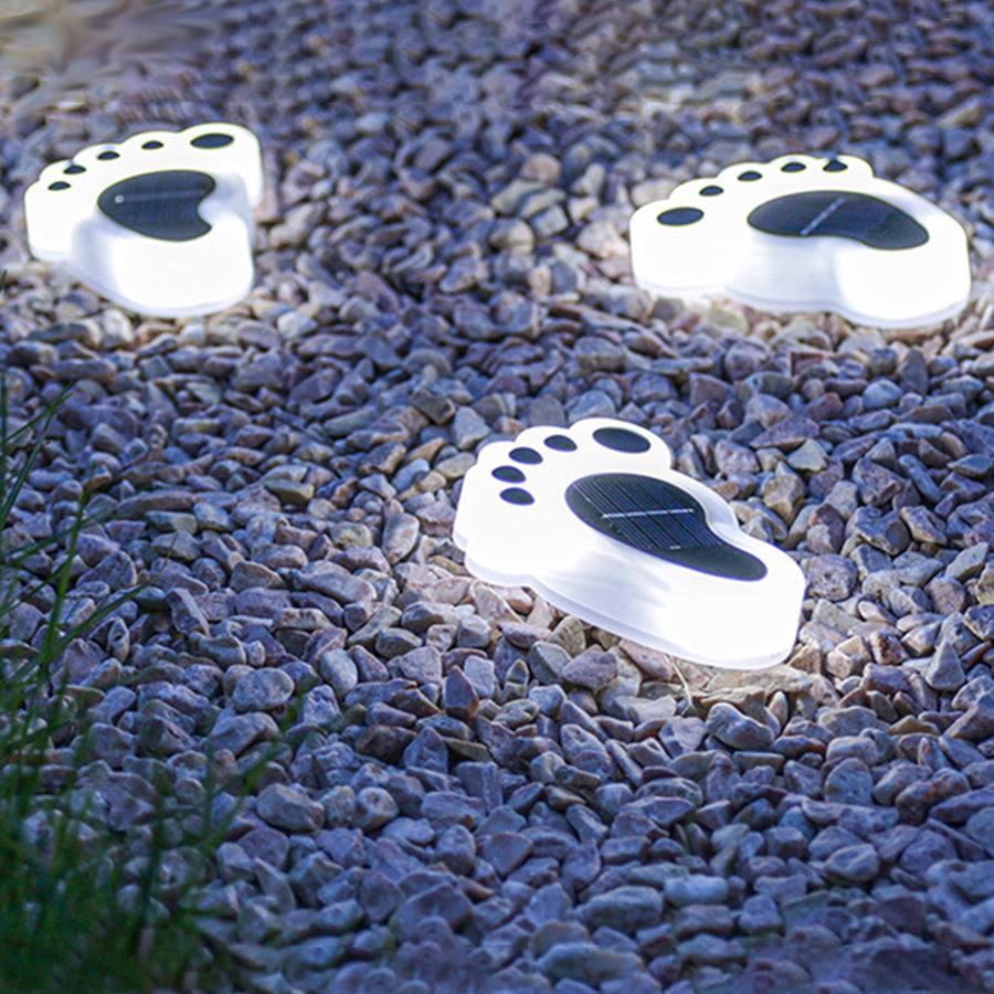 Blue decorative stone surface featuring multiple white solar footprint lights for outdoor decoration