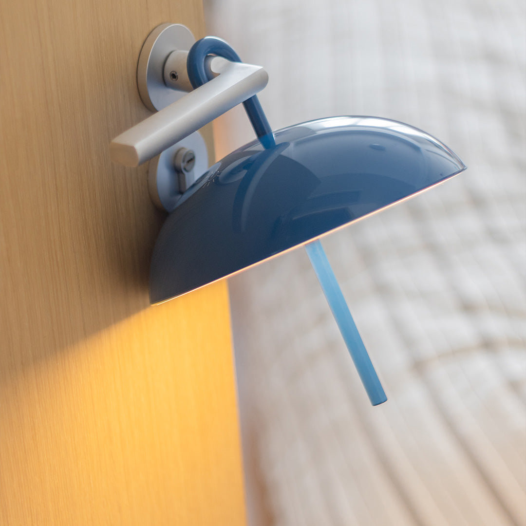 Blue dome USB rechargeable table lamp on bedside table for nighttime reading