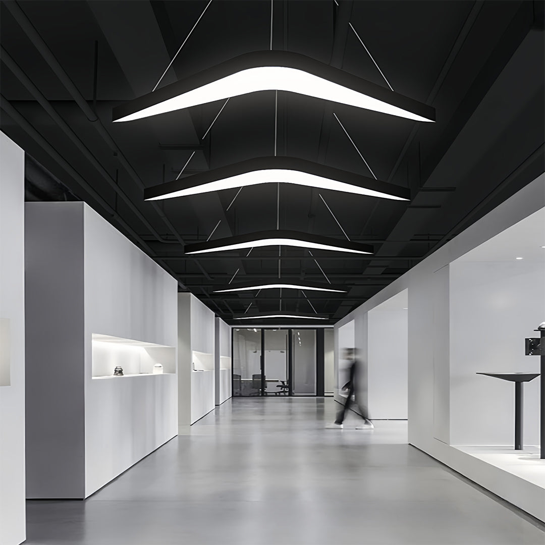 Dynamic black wrought iron chandelier with bold curves, offering dramatic lighting for a contemporary environment.