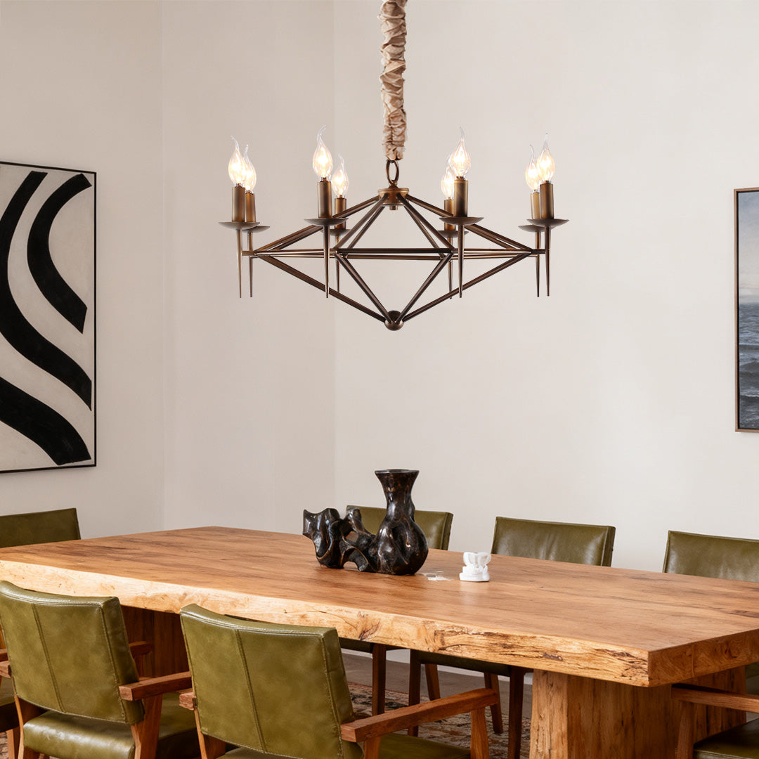 A bold brown chandelier providing task lighting over a large, live-edge wood dining table with dark green leather chairs.