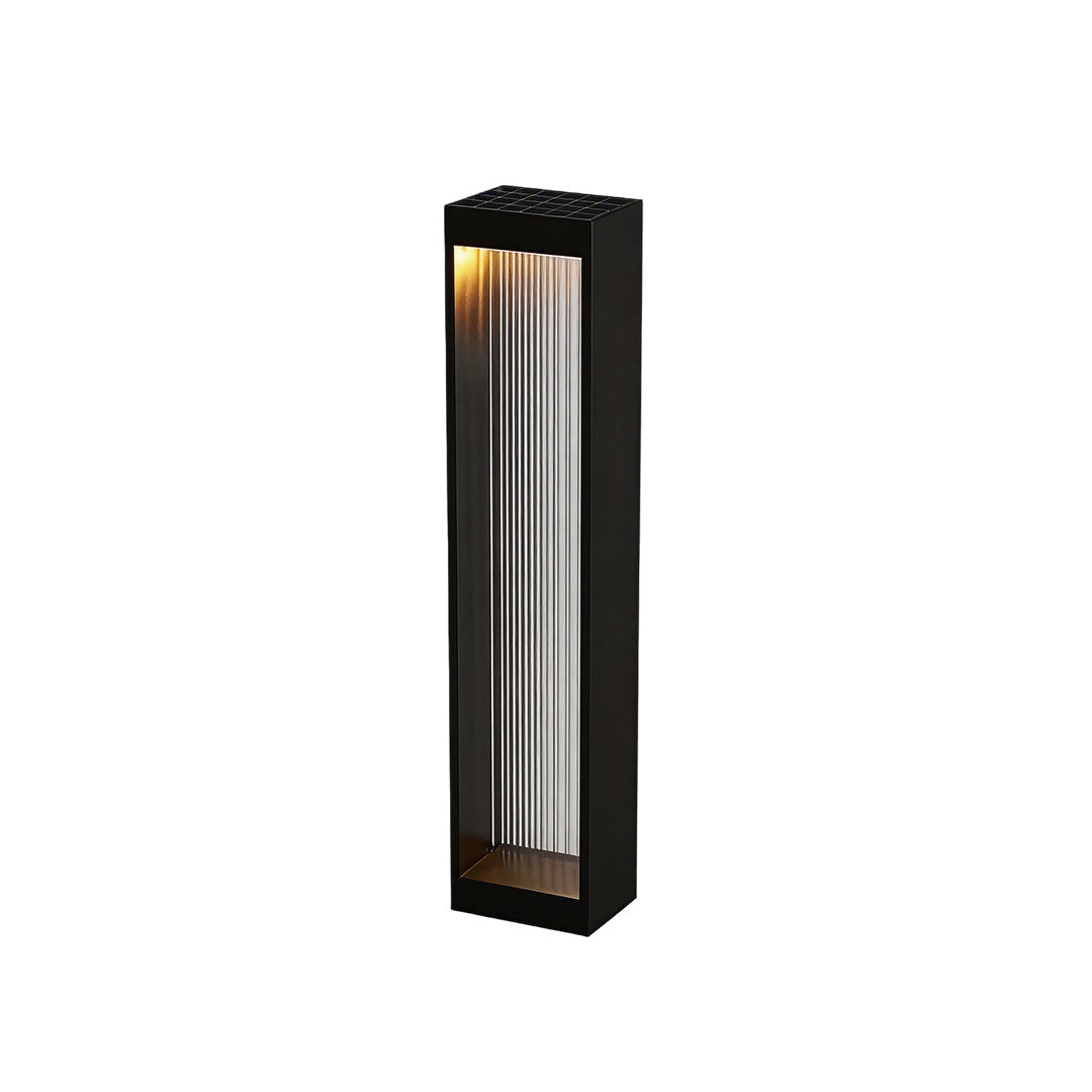 Bollard garden lights with a modern design, placed near a garden fence.
